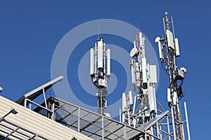 Mobile towers on blue sky background. Many communication equipment