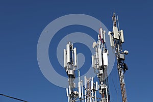 Mobile towers on blue sky background. Many communication equipment