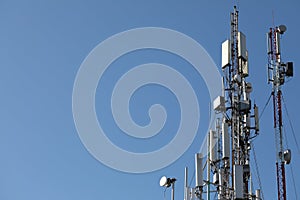 Mobile towers on blue sky background. Many communication equipment
