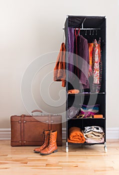 Mobile wardrobe with clothing and leather suitcase