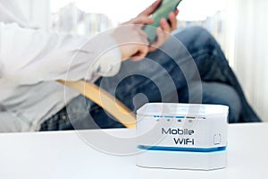 Mobile WiFi router device on the table and businessman