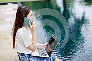 Mobile Work and Leisure, Woman on Vacation Answers Emails on Smartphone by the Pool