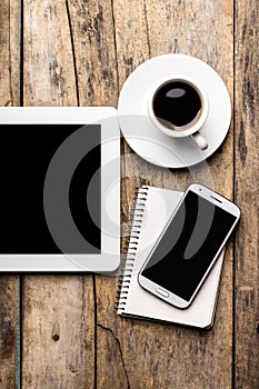 Mobile workplace with tablet PC, phone and cup of coffee