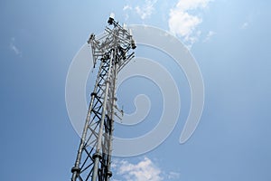 Mobility cell site against a cloudy sky, self-supporting tower with panel antennas