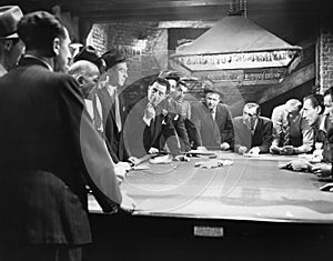 Mobsters meeting around pool table