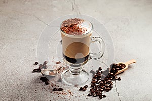 Mocaccino coffee in a glass mug with beans