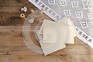 mocap retro, old family photographs, pictures, home archive documents on vintage wooden table, lace doily, concept of family tree
