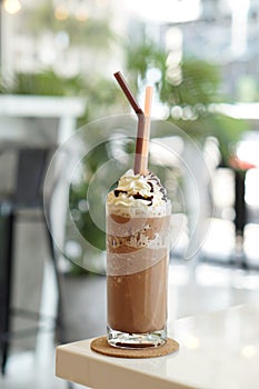 Close up of mocha coffee with whiped cream and nature bokeh background. photo