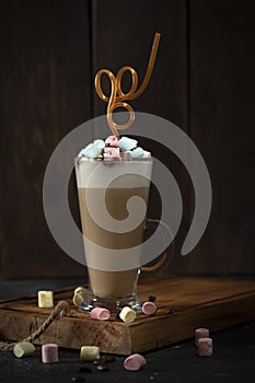 Mocha Coffee with marshmallow in glass on the wooden table