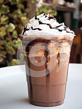 Mocha frappe in plastic cup. Served with whipping cream and chocolate sauce. Freshness drink. Favorite caffeine beverage