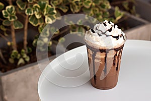 Mocha frappe in plastic cup. Served with whipping cream and chocolate sauce. Freshness drink. Favorite caffeine beverage menu