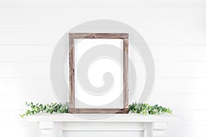 Mock up A4 vertical frame made of rough wood with on a shelf with greens