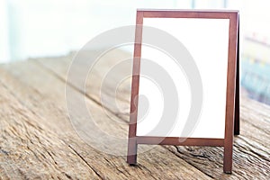 Mock up blank advertising whiteboard with easel standing on wood