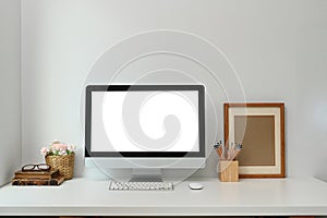 Mock up of blank computer pc on the desk on white table in living room.