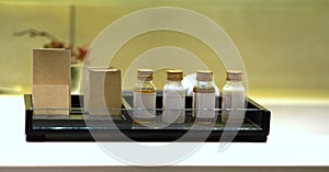 Mock up blank label bottles and brown paper box in tray collection container on blur background