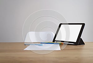 Mock up blank screen tablet, white paper and colour pencil on office desk table, work space or study room at home, Back to school