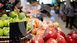 Mock up blank sign price tag display in supermarket Interior, apple basket
