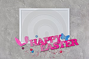 Mock up of blank white frame with pink text of happy easter and bunny ears