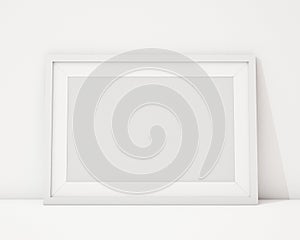 Mock up blank white horizontal picture frame on the white interior background