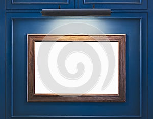 Mock up Blank Wooden Frame on blue wall with spot light Interior