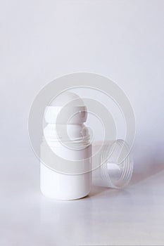 Mock up a bottle of deodorant with shadow. Front. Light background