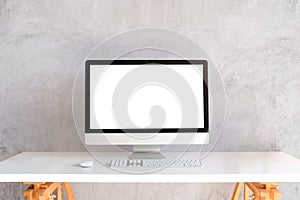 Mock up computer with empty screen on white table with cement wall