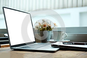 Mock up computer laptop, notebook, pen and coffee cup on wooden table