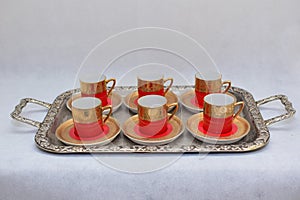 Mock up / design set of elegant and traditional colorful Red and gold traditional elegant coffee cup & Tea cup on cup`s plate besi