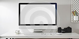 Mock up desktop computer with camera and office supplies in modern office style