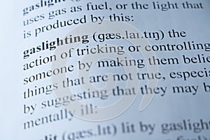 Dictionary page with the word gaslighting with selective focussing