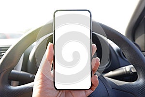 mock up driver hand holding phone in car empty clear screen for text- advertise copy-space background- image