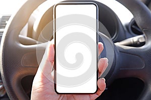 mock up driver hand holding phone in car empty clear screen for text- advertise copy-space background- image