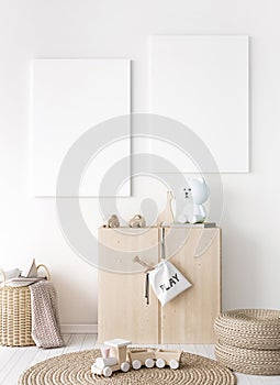 Mock up frame in children room with natural wooden furniture, two vertical frames on white wall