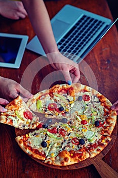 Mock up freelancer workplace. Tablet PC, cell phone and pizza. Top view image. Fast pizza delivery