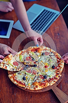 Mock up freelancer workplace. Tablet PC, cell phone and pizza. Top view image. Fast pizza delivery