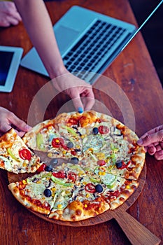 Mock up freelancer workplace. Tablet PC, cell phone and pizza. Top view image. Fast pizza delivery