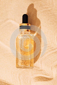 A mock-up glass bottle with a pipette with an intensive moisturizing concentrate with hyaluronic acid and vitamins on a background photo