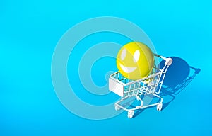Mock up hapiness emoticon ball on cart,trolley for supermarket shopping concepts idea photo