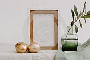 Mock Up Happy Easter. Gold eggs, frame and olive brunch