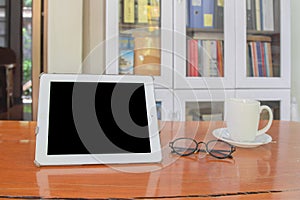 Mock up image of white tablet pc with black blank screen and cof