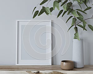 Mock up interior with a frame for a poster and a vase with a