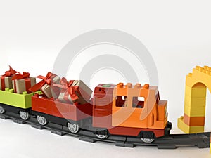 Mock up kids toys composition with colorful toy train with gifts on railway on white background.