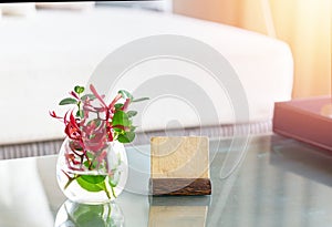 Mock up label stand with flower water vase on table  in room for welcome reception concept