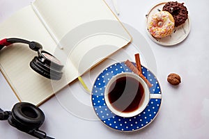 Mock up notepad with headphones, coffee cup with doughnuts. Online work, freelance, taking webinar, listen to music or