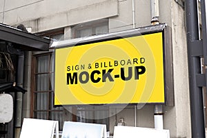 Mock up outdoor billboard on the wall near glass windows