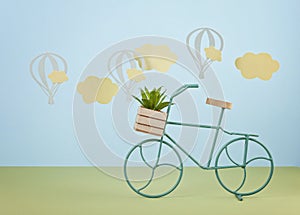 Mock up with paper clouds and flying balloons over the blue pastel background and  toy bicycle