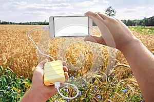 Mock Up of the phone and the bank in the hand of a man, against the background of a yellow field
