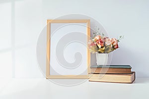 Mock up portrait photo frame with green plant on table, home dec
