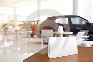 Mock up poster board stand on sales promotion advertisement sign white display on table in car show room