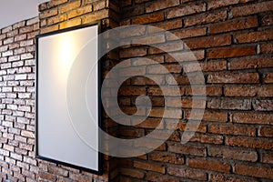 Mock up poster on brick wall. Template display for your adverting or branding in loft style interior